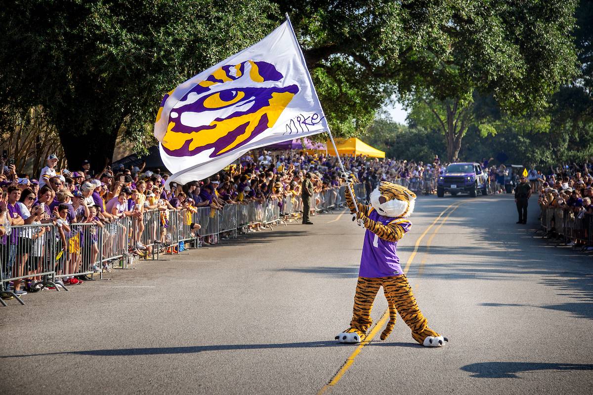 Mike the Tiger waves a flag 