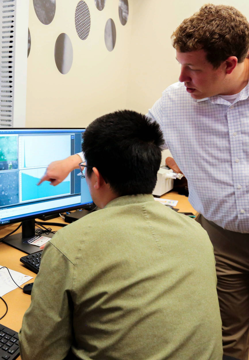 Chris Marvel collaborates with Ching-Heng Shiau, an LSU scanning transmission electron microscopy specialist at a computer screen.