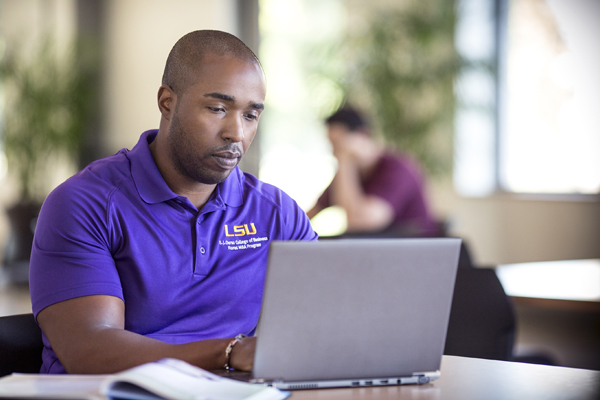 Man typing on laptop.