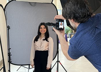 female smiles while getting photo taken