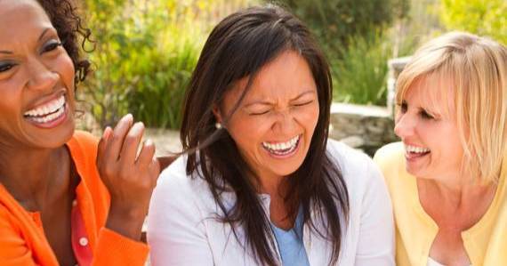 Three women laughing.