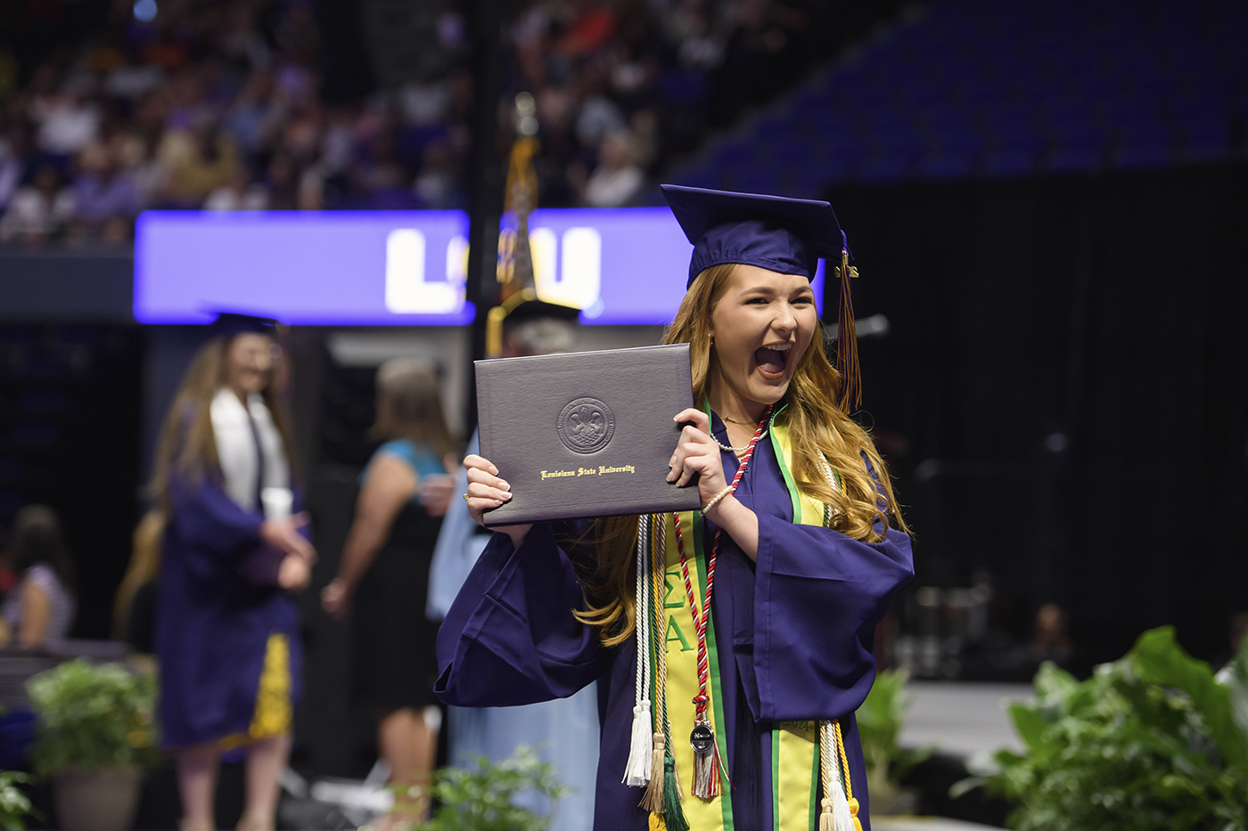 graduate holding up diploma