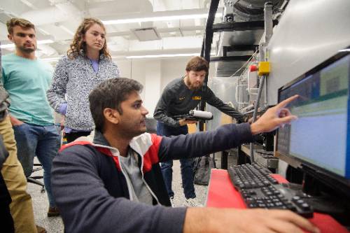 Man showing students something on a screen