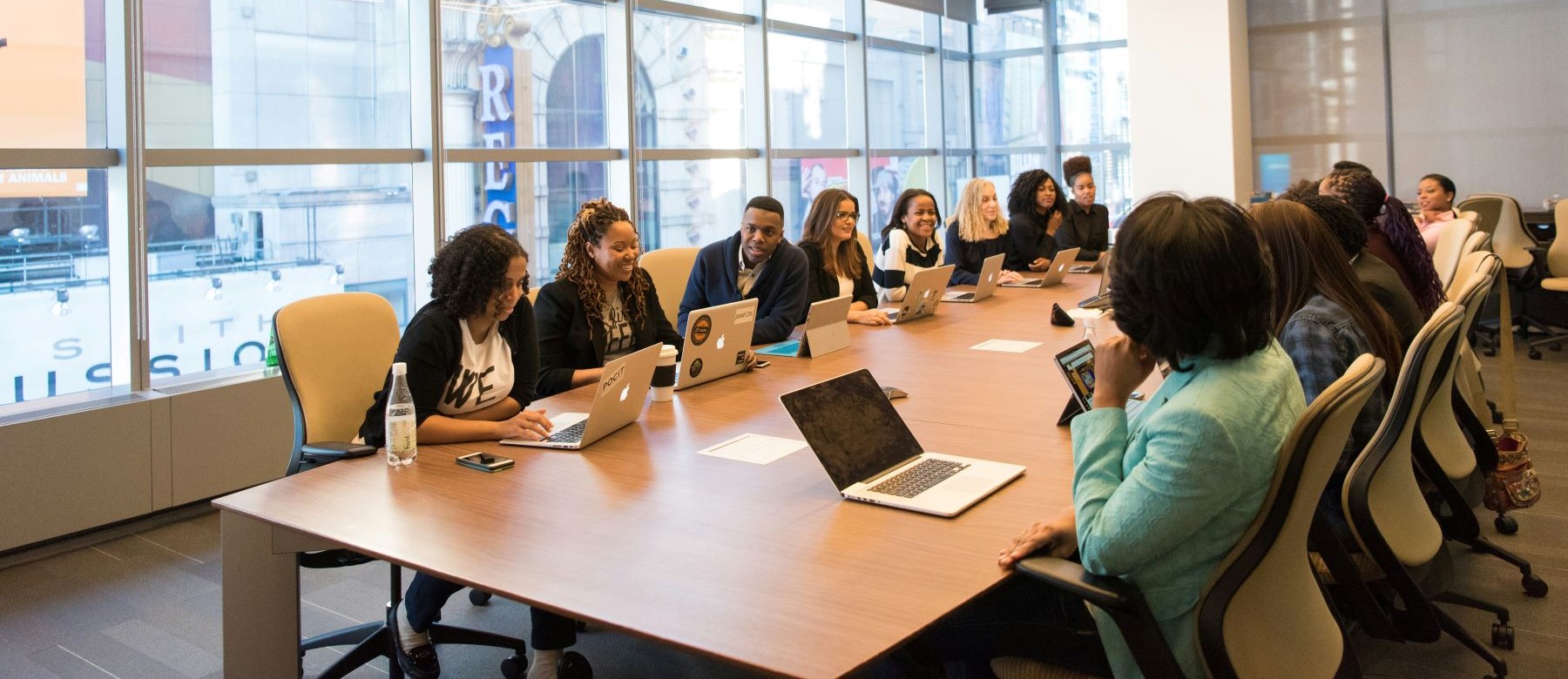 large group of people sit around a conference table