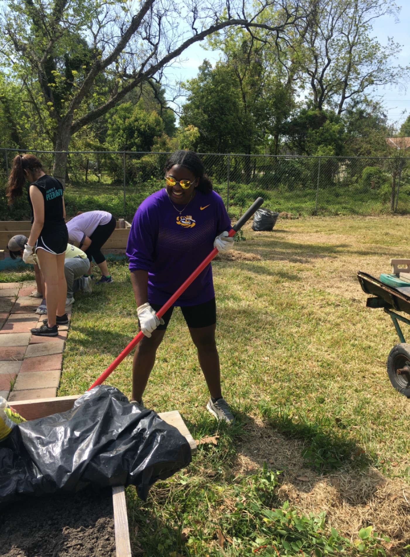 Layah digs up tree at community service event.