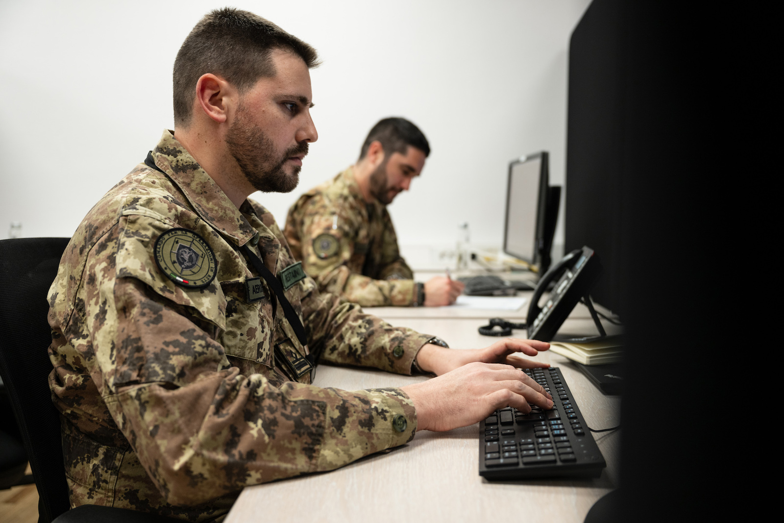 two representatives at computers during a training session