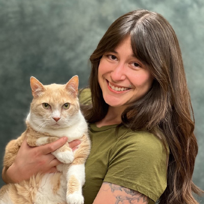 Christina holds a cat. 